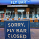 A sign informing passengers that the Fly Bar at Dallas's Love Field Airport is closed in June 2020; used here as stock photo.